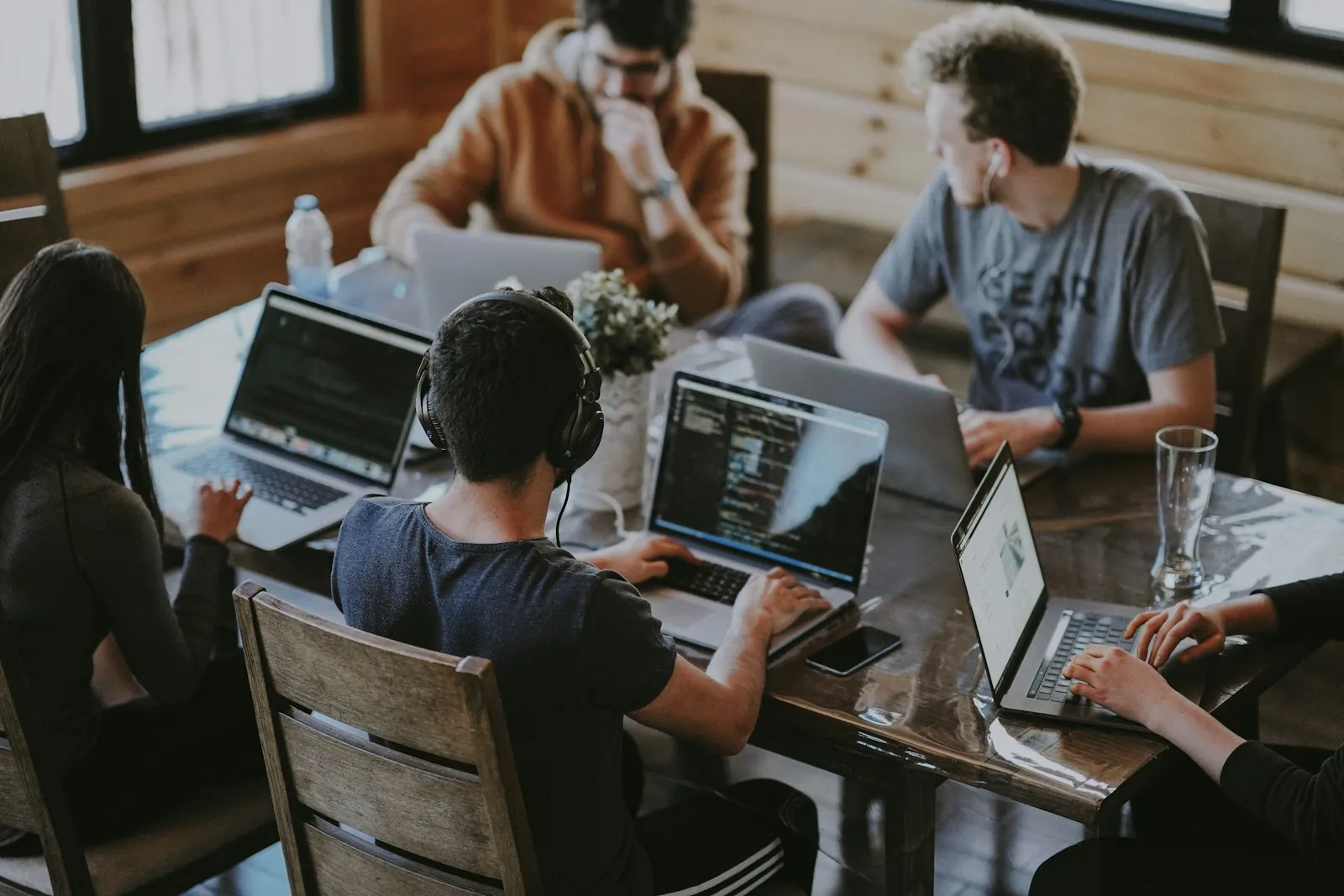 Executive reviewing financial summaries with advisors at a conference table, illustrating strategic finance visibility and governance-ready reporting discussions.